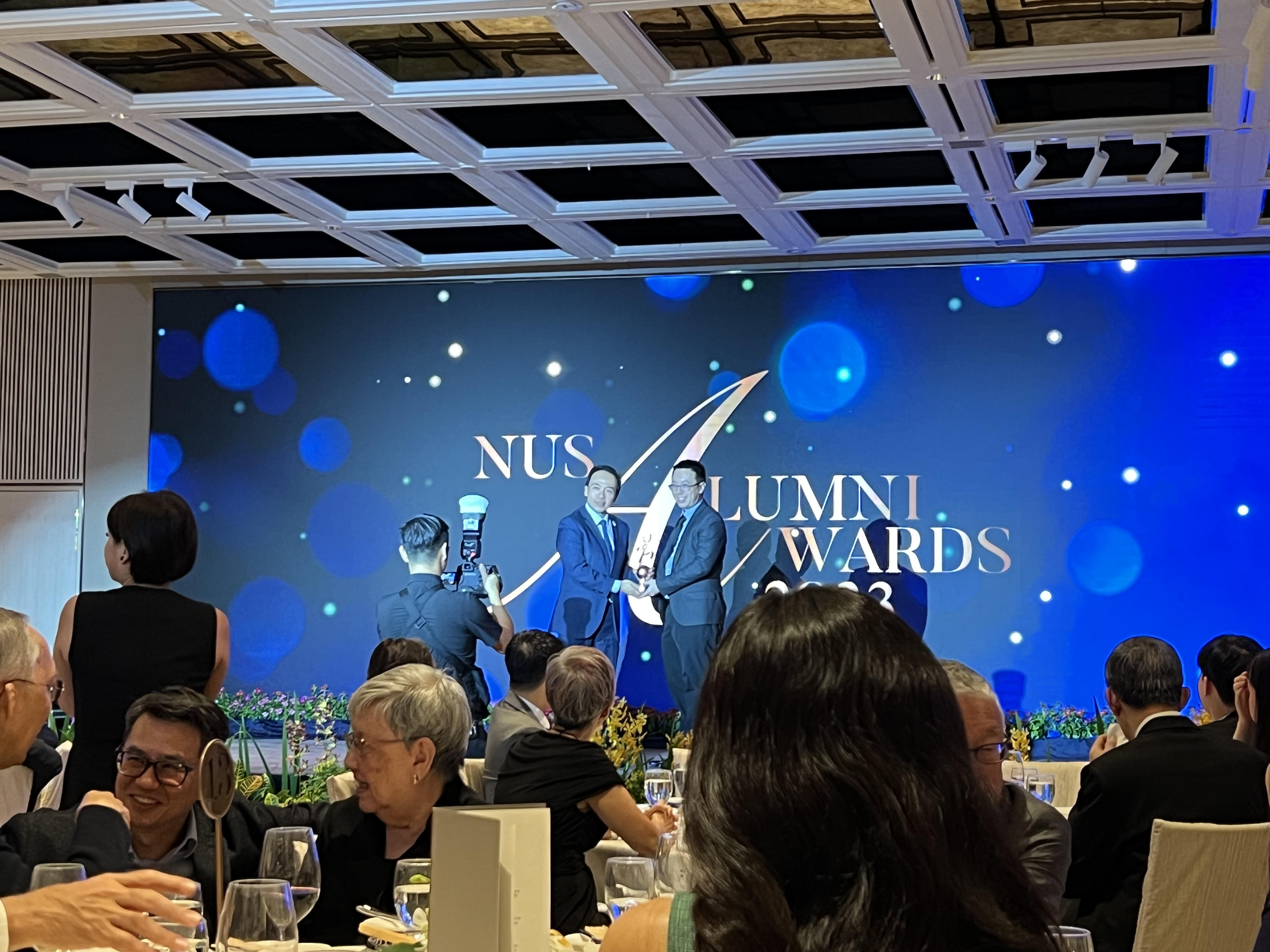 Historical storyteller Shawn Seah receiving an award from the National University of Singapore, at the NUS Alumni Awards 2023. 