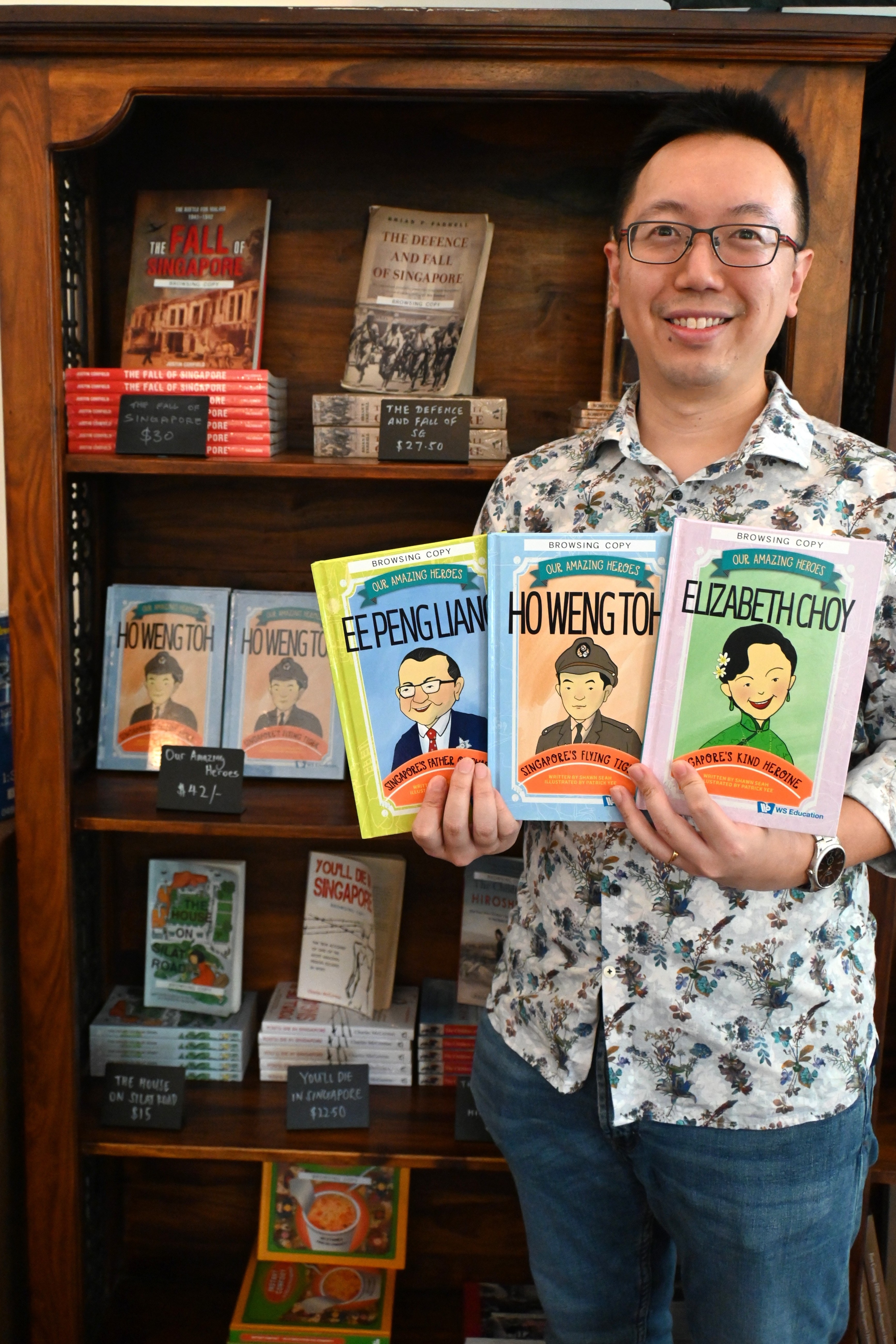 Author and speaker Shawn Seah with his children's book series, Our Amazing Heroes, at the Battlebox Singapore shop. 