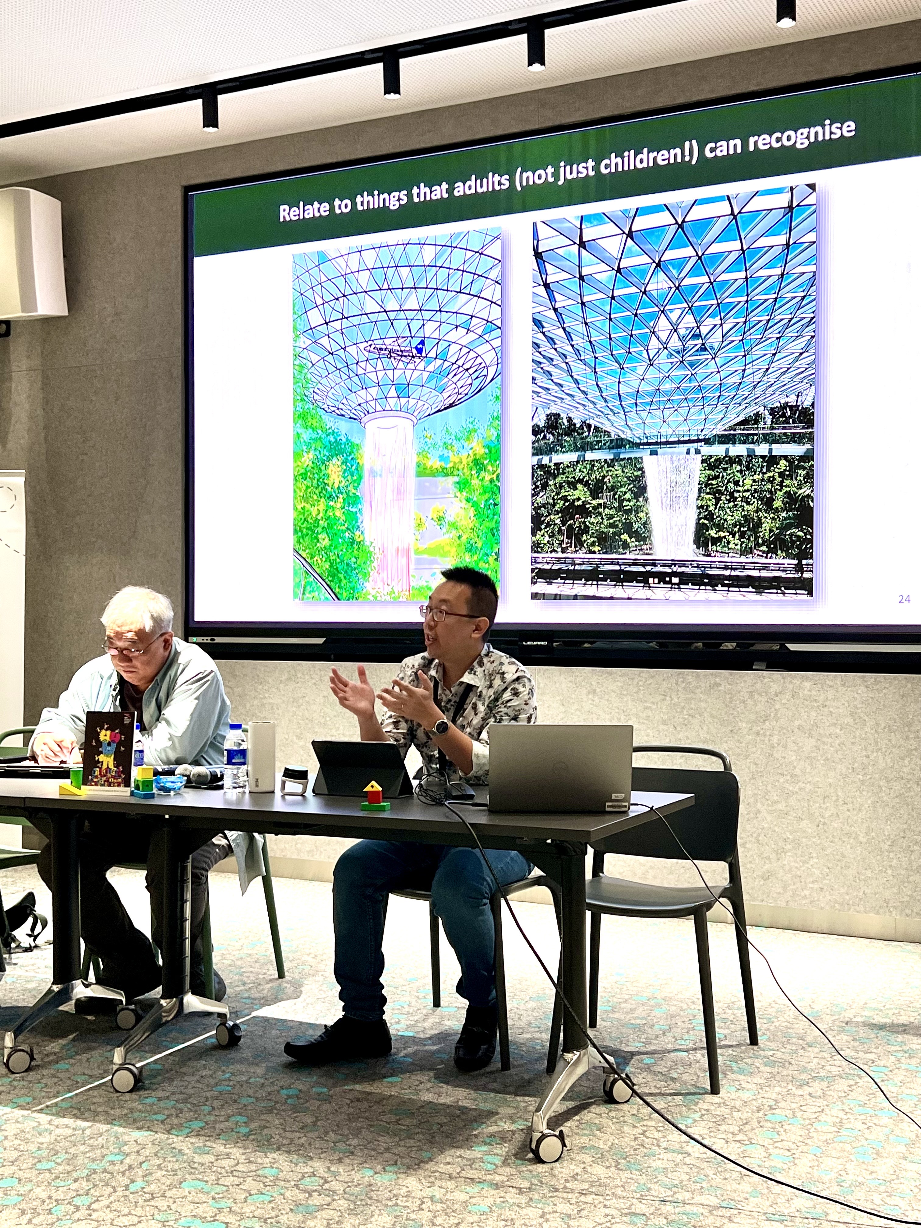Author and speaker Shawn Seah speaks at the Asian Festival of Children's Content with illustrator David Liew sitting on his right.