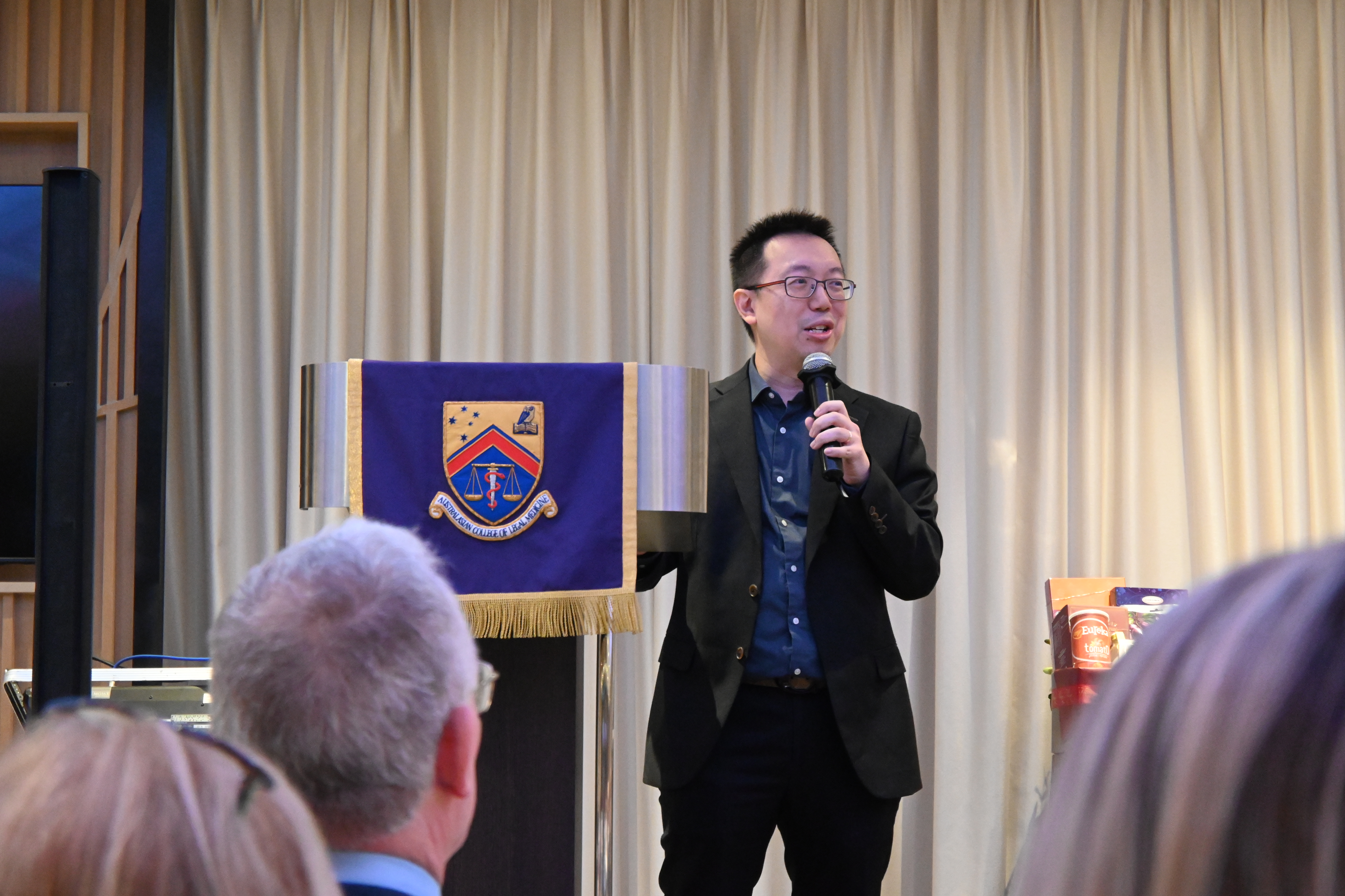 Author and speaker Shawn Seah speaking on stage at the ACLM Awards Dinner 2025. 
