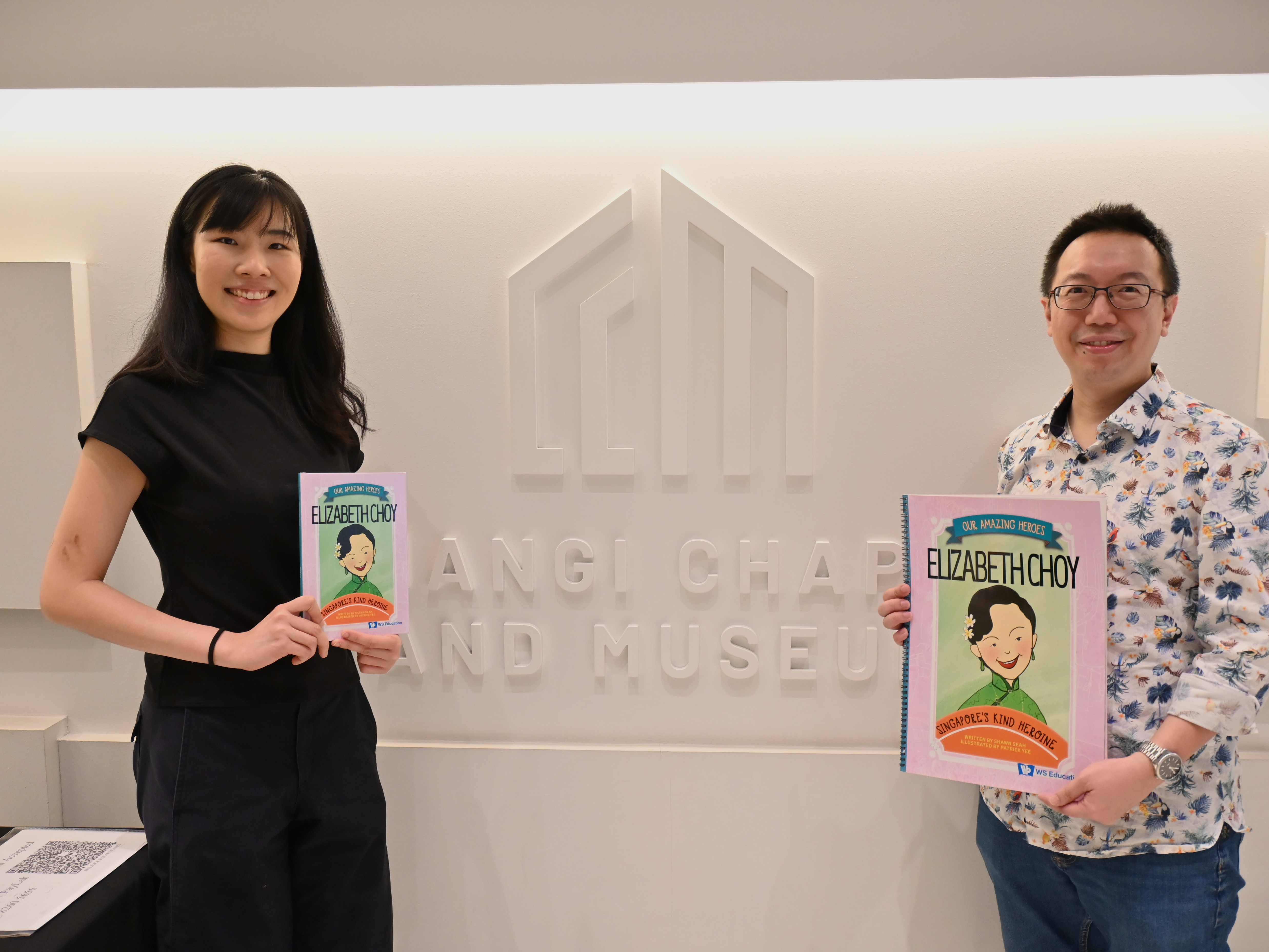 Performer Tanya Ang and author Shawn Seah holding up books on Elizabeth Choy: Singapore's Kind Heroine. 
